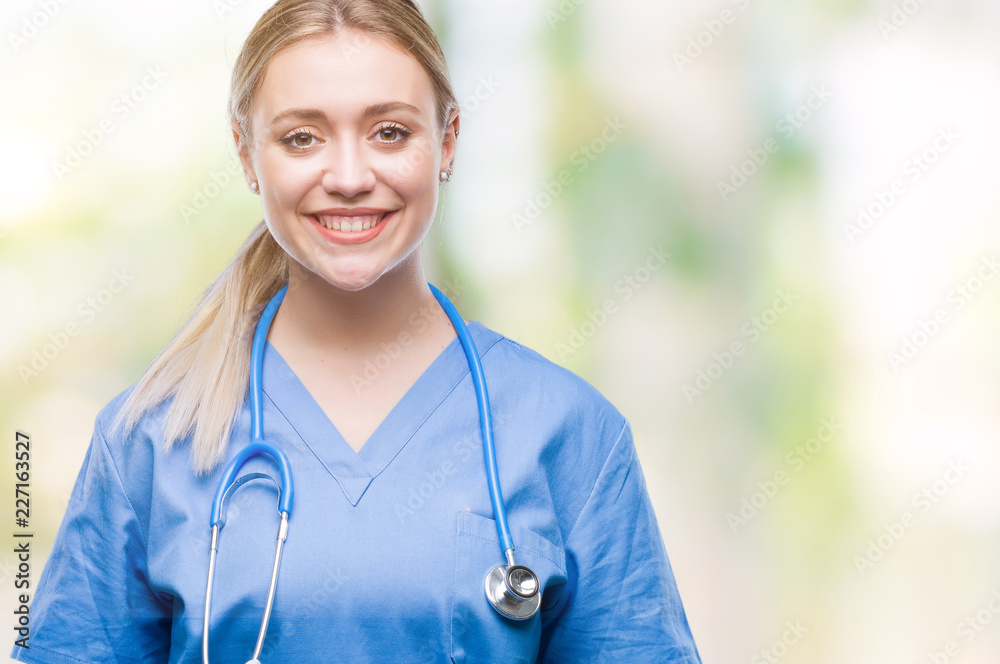 Young blonde surgeon doctor woman over isolated background with a happy and cool smile on face. Lucky person. Young blonde surgeon doctor woman over isolated background with a happy and cool smile on face. Lucky person.
