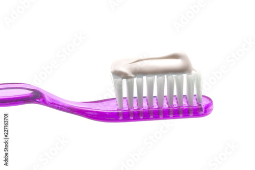 Simple Toothbrush on a White Background with Toothpaste Applied to the Bristles
