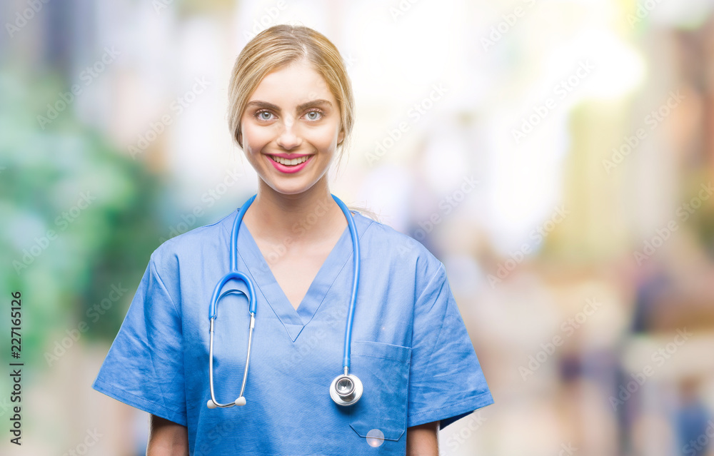 Young beautiful blonde doctor surgeon nurse woman over isolated background with a happy and cool smile on face. Lucky person. Young beautiful blonde doctor surgeon nurse woman over isolated background with a happy and cool smile on face. Lucky person.