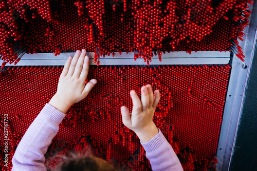 Child Playing with Science Exhibit