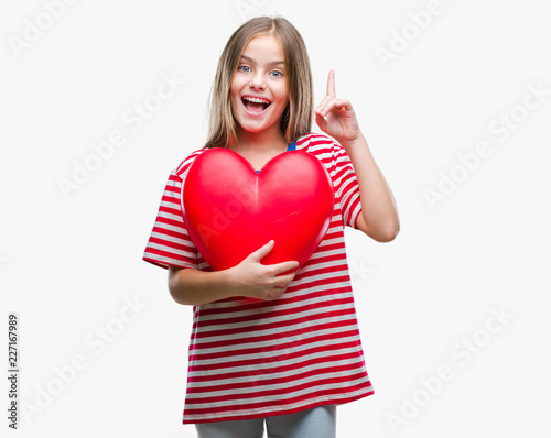 Young beautiful girl holding red heart over isolated background surprised with an idea or question pointing finger with happy face, number one
