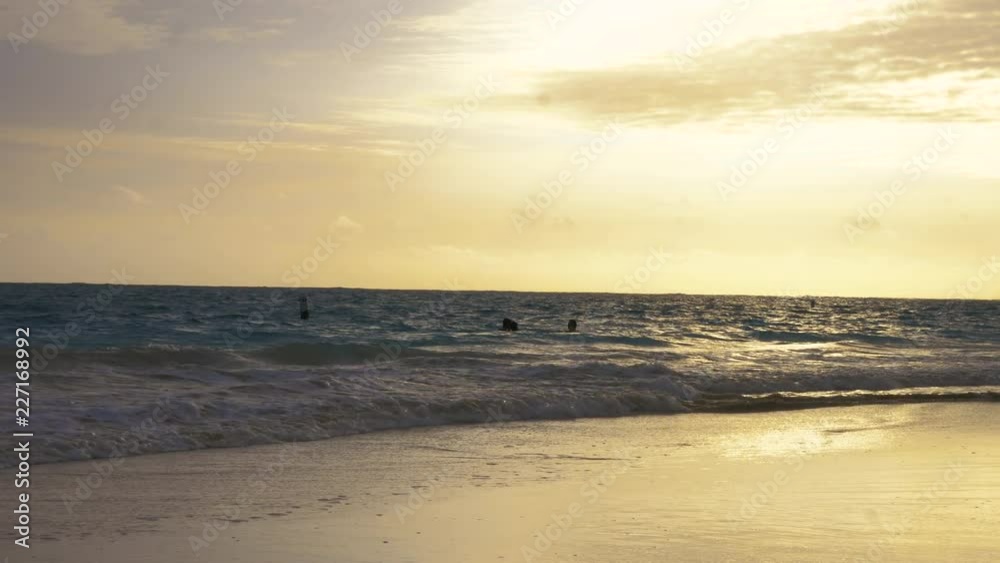 People Swimming in Ocean at Sunset. hand held view of people swimming in the ocean at sunset People Swimming in Ocean at Sunset. hand held view of people swimming in the ocean at sunset
