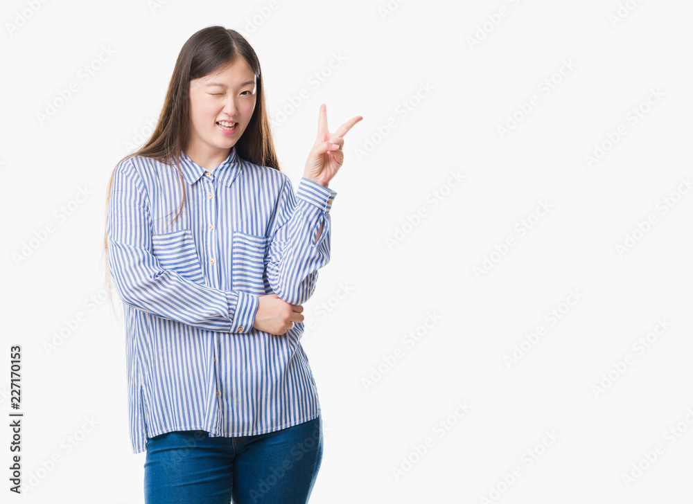 Young Chinese woman over isolated background smiling with happy face winking at the camera doing victory sign. Number two. Young Chinese woman over isolated background smiling with happy face winking at the camera doing victory sign. Number two.