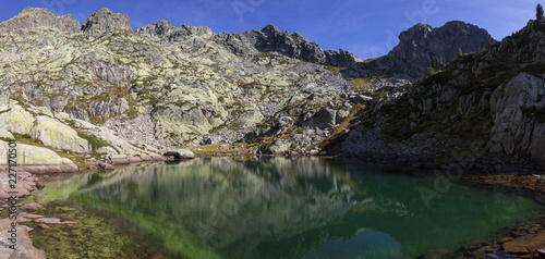 Fototapeta Naklejka Na Ścianę i Meble -  Autumn hiking in Aosta valley, Gressoney, Italy. Alpine lake of Goudin dominate by Mont Mars on the left.