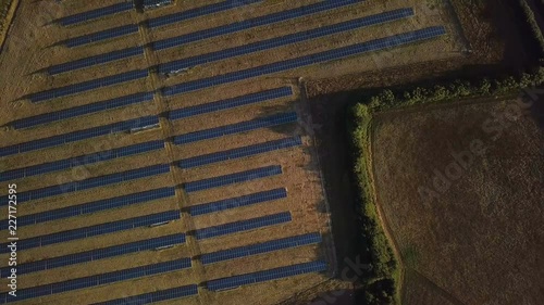 Birds Eye View of Sunny Solar Panels in Field - 4K Aerial Footage photo