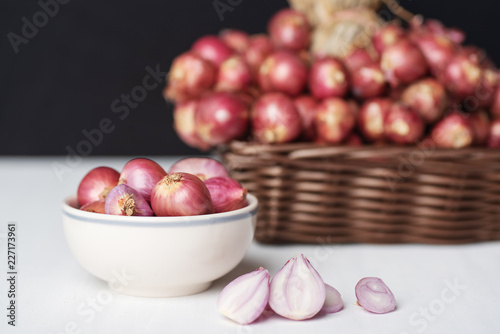 Red shallot onion in a bowl and basket, herb and spice, food ingredient