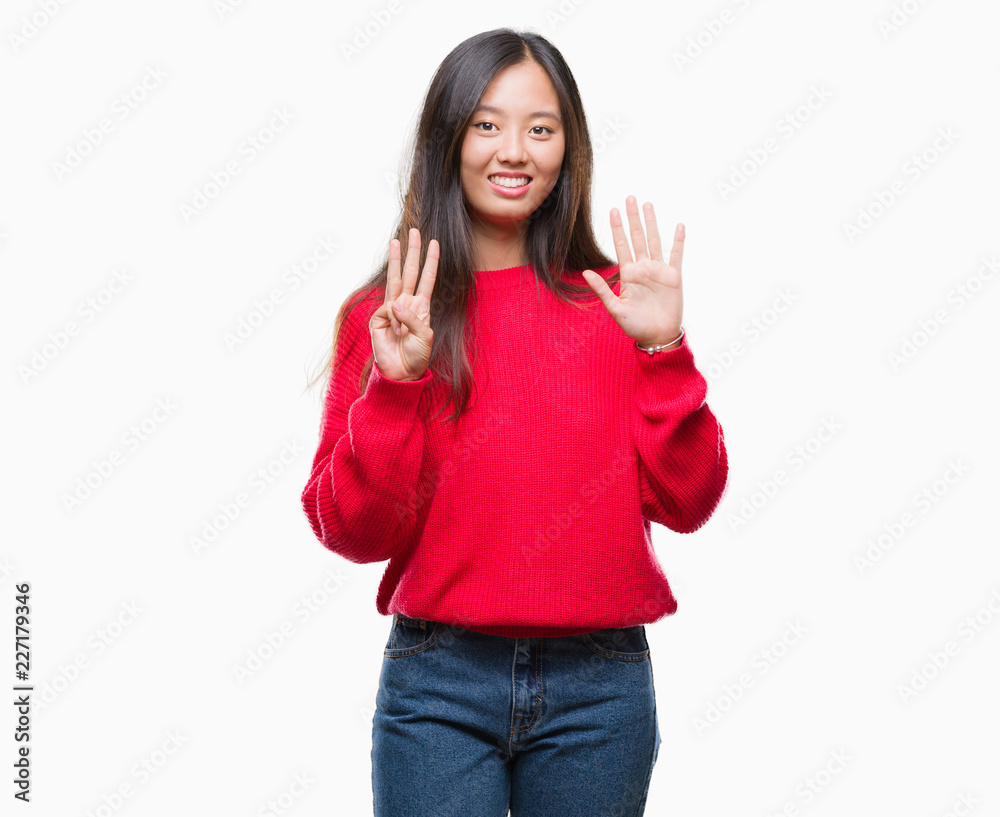 Young asian woman wearing winter sweater over isolated background showing and pointing up with fingers number eight while smiling confident and happy. Young asian woman wearing winter sweater over isolated background showing and pointing up with fingers number eight while smiling confident and happy.