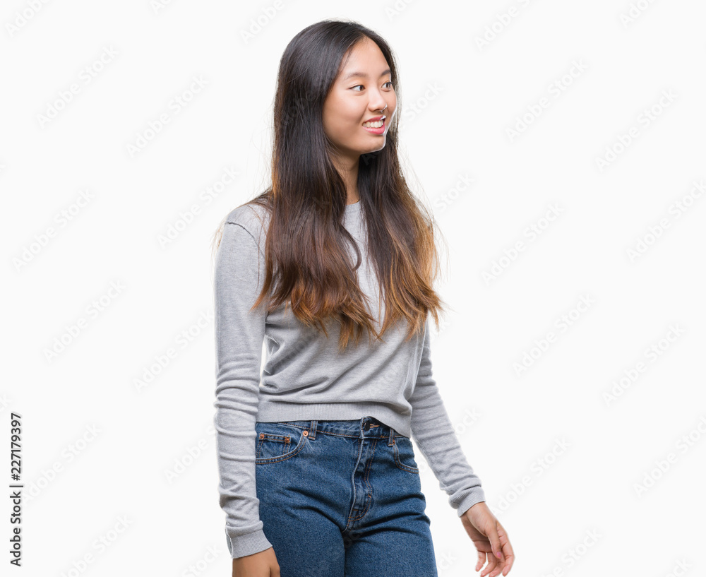 Young asian woman over isolated background looking away to side with smile on face, natural expression. Laughing confident. Young asian woman over isolated background looking away to side with smile on face, natural expression. Laughing confident.