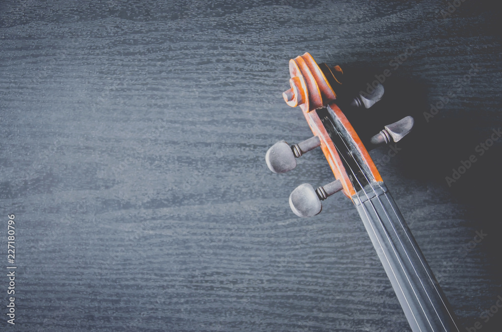 The violin on the dark table, Classic musical instrument used in the orchestra. The violin on the dark table, Classic musical instrument used in the orchestra.