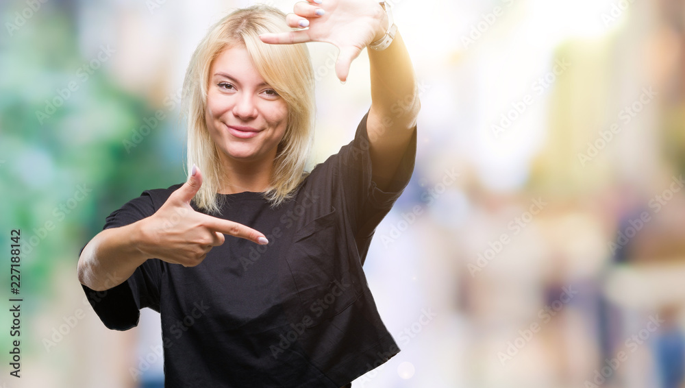 Fototapeta premium Young beautiful blonde woman over isolated background smiling making frame with hands and fingers with happy face. Creativity and photography concept.