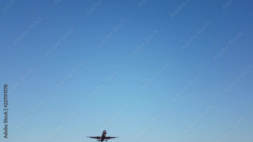Jet Flys Over Head. Looking up toward the sky, an airplane flies over head and lands at an airport during sunset. Jet Flys Over Head. Looking up toward the sky, an airplane flies over head and lands at an airport during sunset.