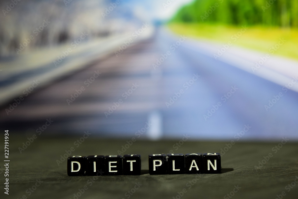 Diet plan on wooden blocks. Cross processed image with bokeh background