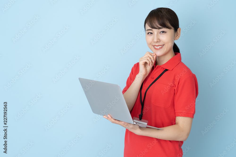 portrait of young asian woman wearing red polo shirts on blue background portrait of young asian woman wearing red polo shirts on blue background