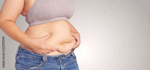 Fat woman touching her stomach