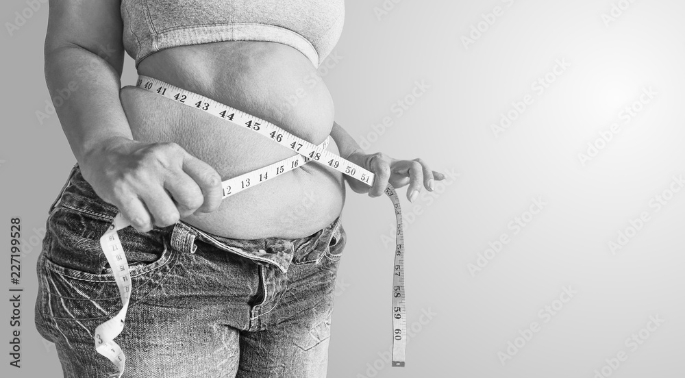 Black and white Fat woman holding a measurement tape.body fat