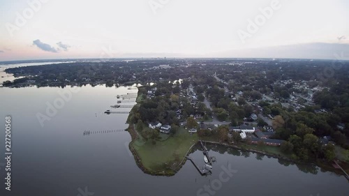 A drone flight taken in the early morning from Portsmouth VA, heading towards Norfolk Virginia showing suburban waterfront. photo