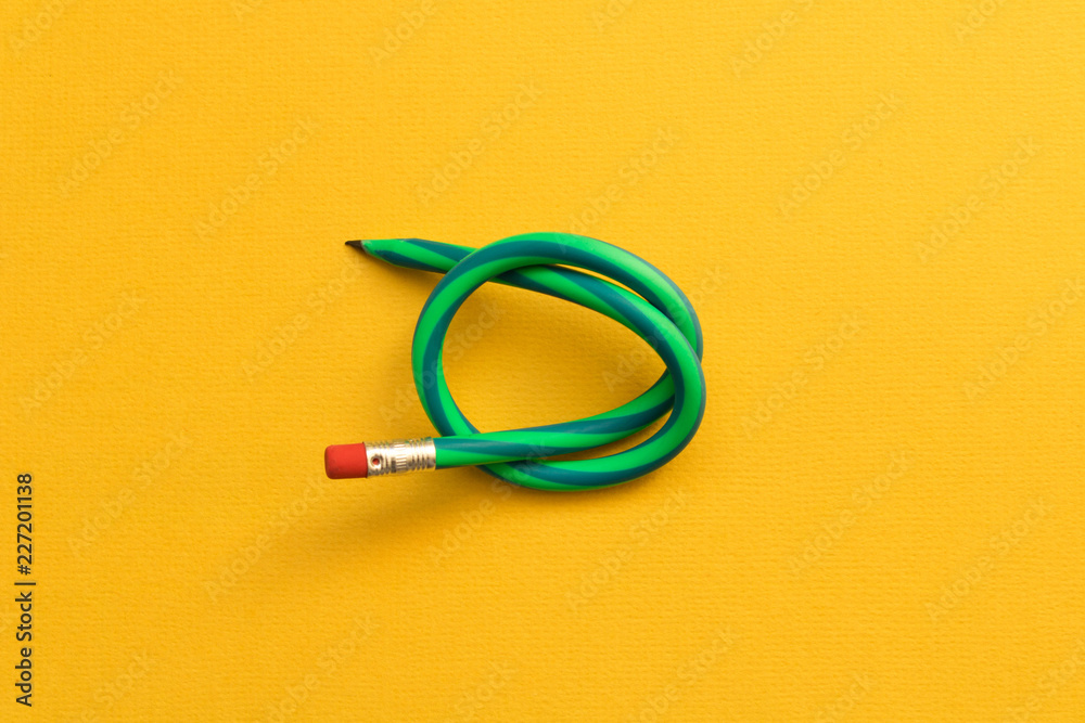 Flexible pencil . Isolated on yellow background Flexible pencil . Isolated on yellow background