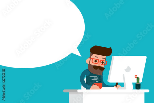 Happy man working on computer with speech bubble.