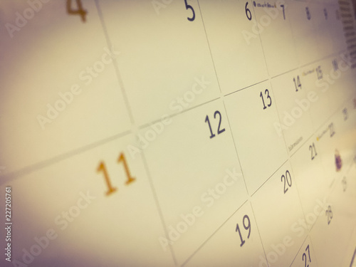 White calendar is adjusted with brown tone, the month are sort by date as the square table which was empty space. Picture in blurred background, for wallpaper or backdrop