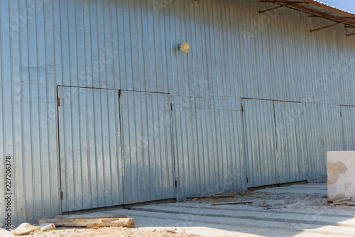 Warehouse of corrugated at the factory. The building is sheathed with sheets of corrugated. Wall decking on the building