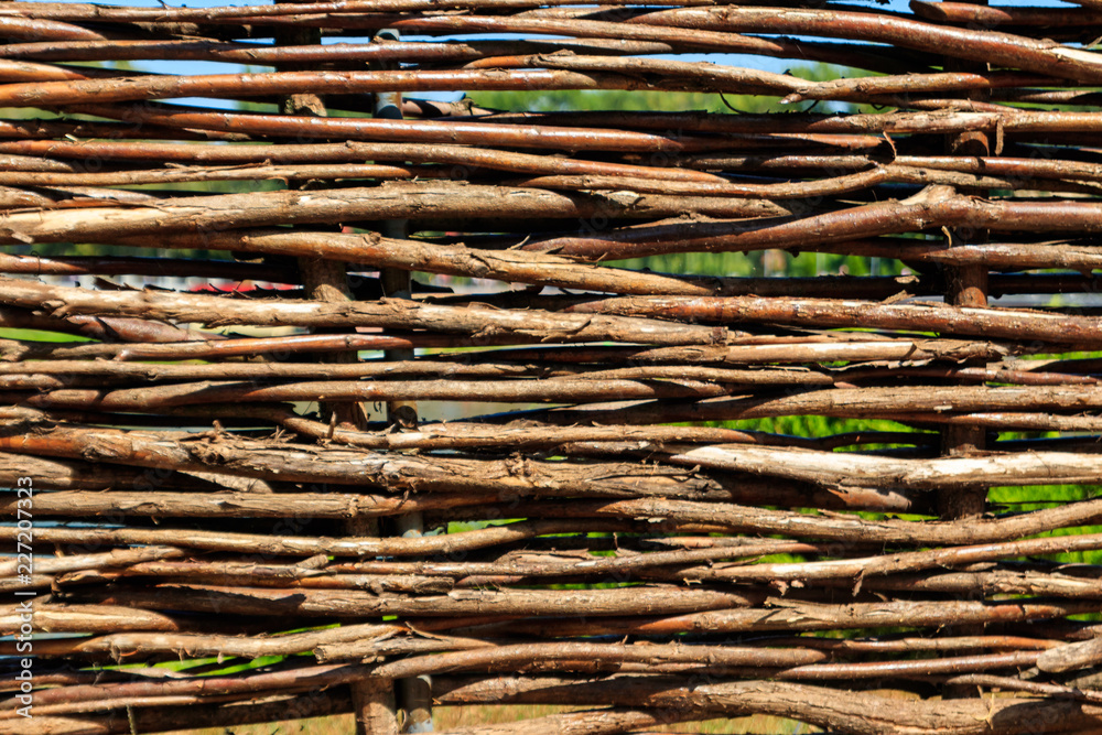 Background of the decorative rustic village wicker fence Background of the decorative rustic village wicker fence