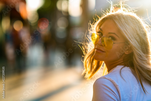 Fotografie Blond girl on white T shirt walking Hollywood Blvd on sunset