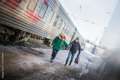 Couple is late for the train at railway station