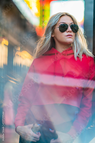 Bild auf Leinwand Blond girl on red hoodie in Hollywood Boulevard