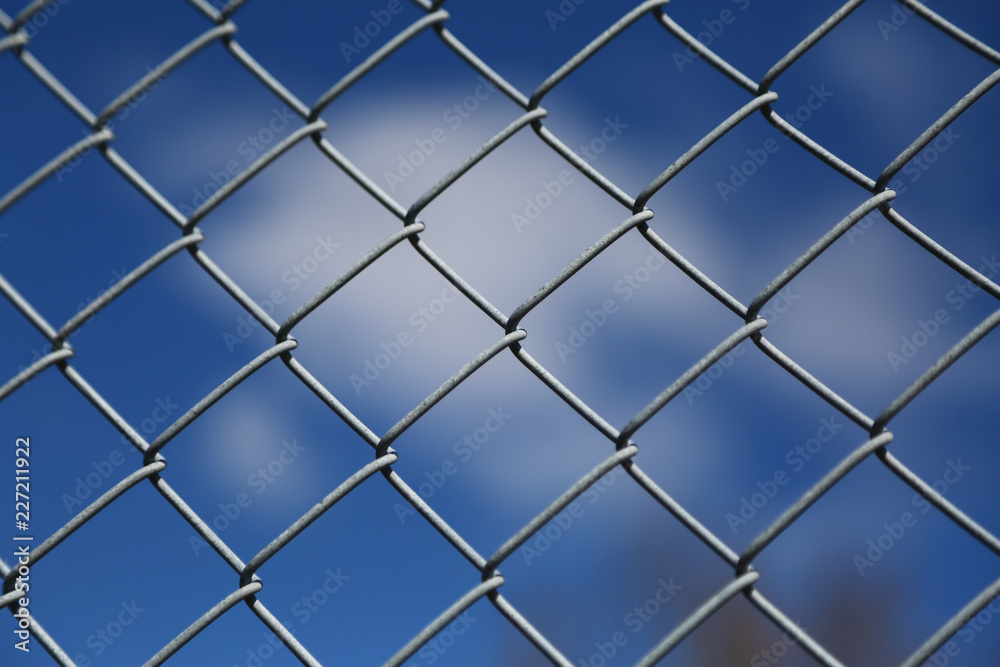 Fototapeta premium Blue Sky Behind the Wire Fence