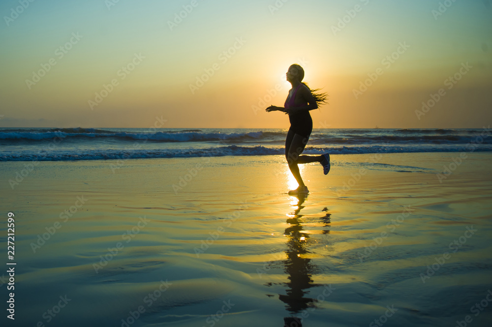 silhouette of young happy and attractive African American runner woman exercising in running fitness workout at beautiful beach jogging and enjoying sunset silhouette of young happy and attractive African American runner woman exercising in running fitness workout at beautiful beach jogging and enjoying sunset