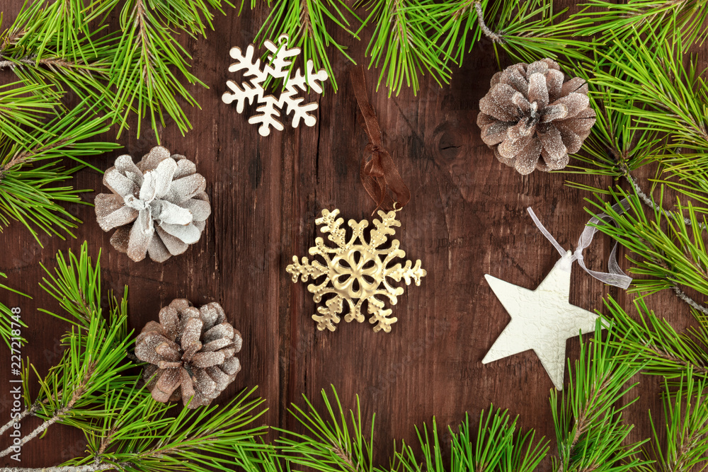 Fototapeta premium Christmas greeting card with fir tree branches, cones, snow, and xmas decorations