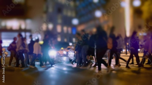 4K City pedestrians at night,crossing big city intersection.No logos or faces,commescial shot.