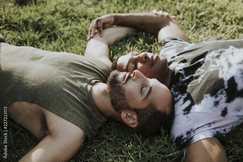 Gay couple relaxing in the grass Gay couple relaxing in the grass