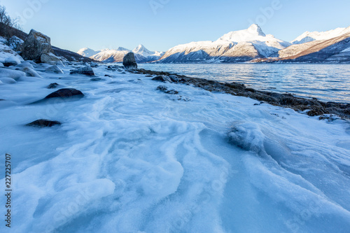 Beautiful winter landscape with icy shore of the fjord