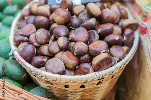 close up of ripe chestnuts in a basket at the farmer's market