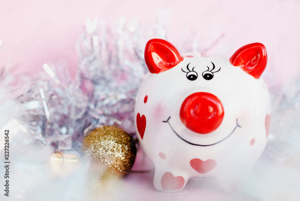 Piggy bank over pink background with christmas decoration copy space. Year of pig 2019. Piggy bank over pink background with christmas decoration copy space. Year of pig 2019.