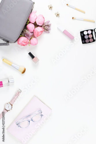 Beauty blog concept flat lay. Fashion accessories, flowers, cosmetics, jewelry, copyspace.