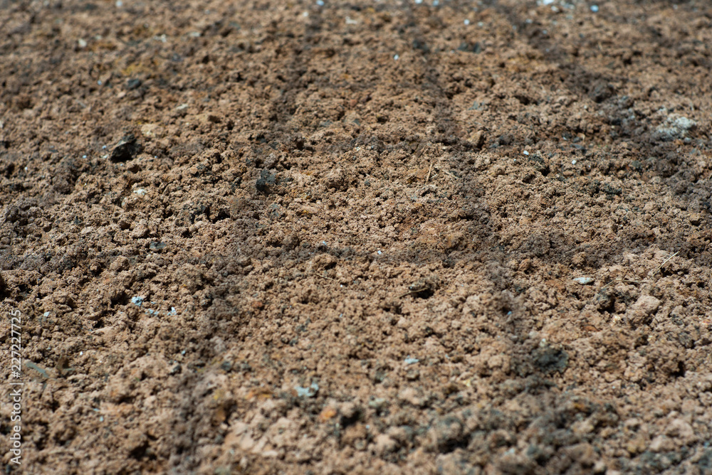 Abstract background and texture of .lateritic soil with the shadow of steel structure on the ground at construction site Abstract background and texture of .lateritic soil with the shadow of steel structure on the ground at construction site