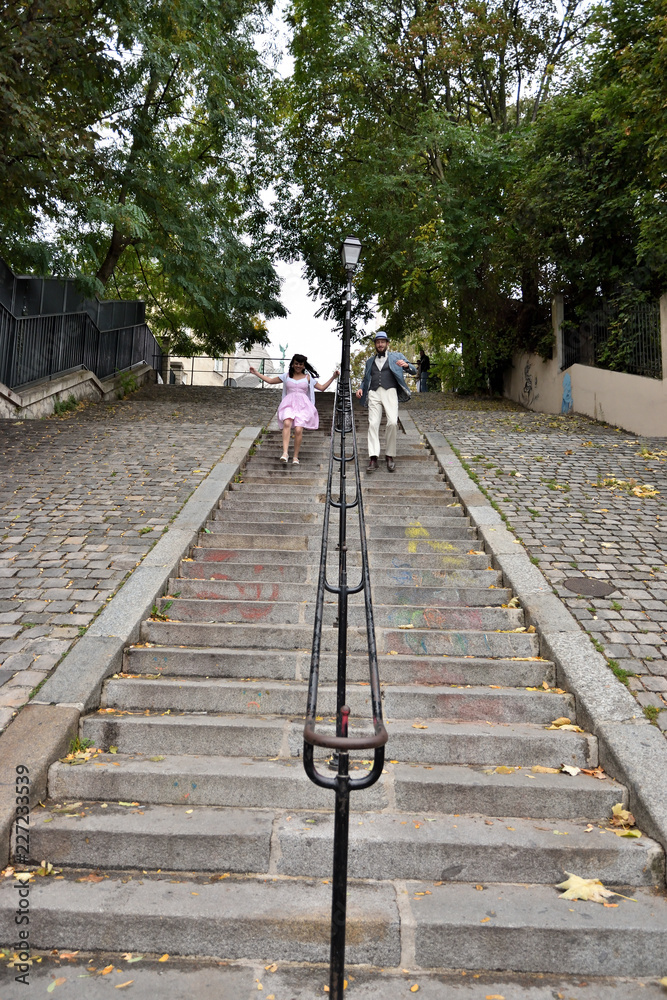 Couple playing in the stairs of Montmartre