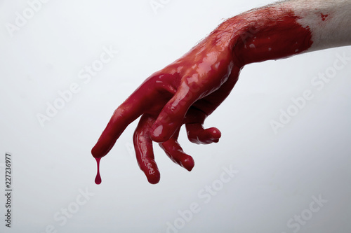 Bloody hand against a light background. halloween horror concept photo