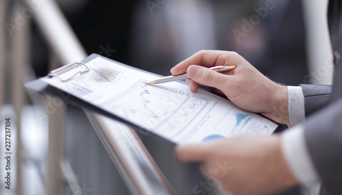 close up. businessman checking financial report in his office