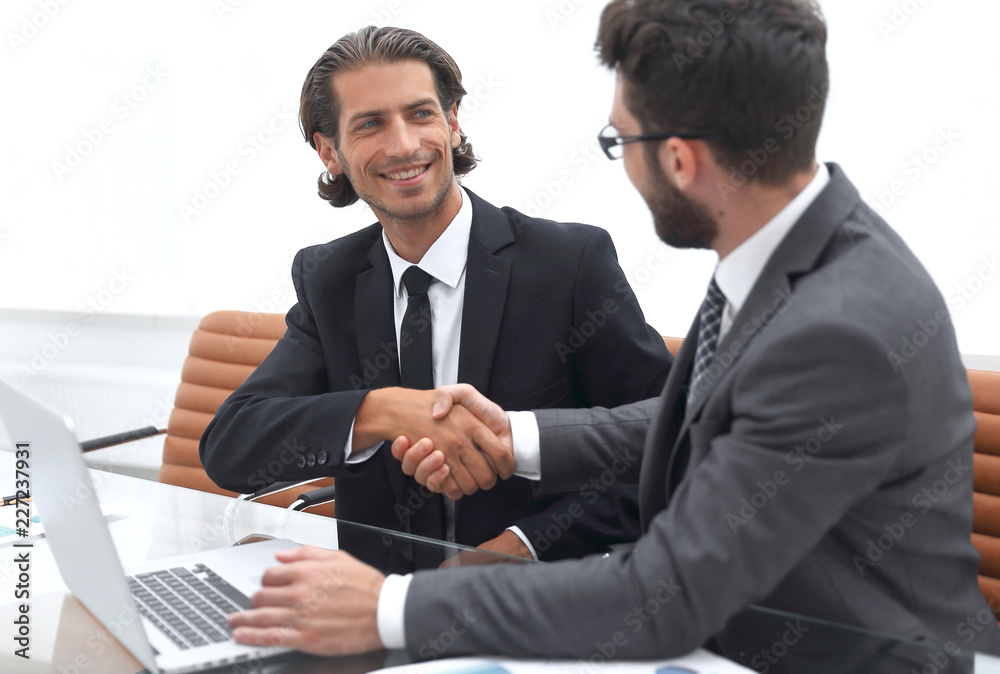 handshake business partners after discussing