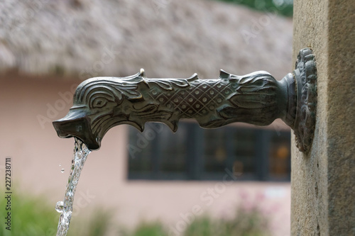 water pouring from iron water fountain head