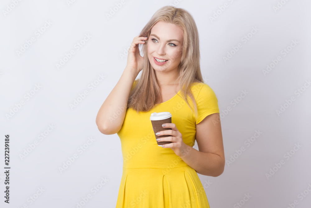 Blonde woman holding coffee cup in her hands Blonde woman holding coffee cup in her hands