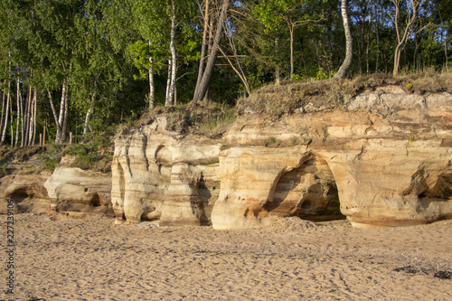 Veczemju Clifs Red Rocks, Latvia. Baltic Sea With Waves, Rocks and Blue Sky Sunny Day.