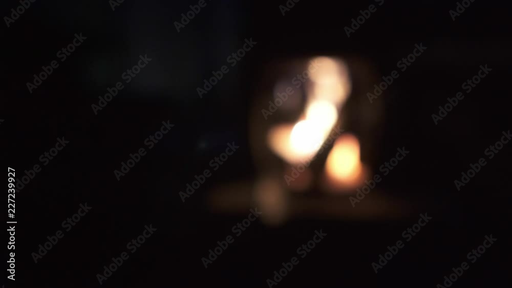 4K Relaxing warm firepit in a cold night in a small ove to warm the surrounding focus pull defocus small aperture
