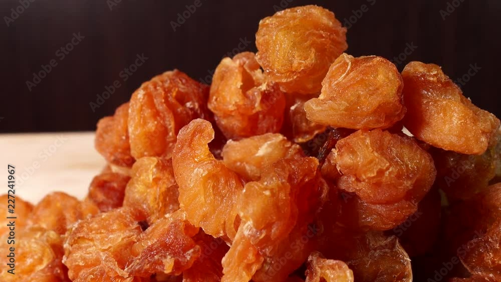 Dried Longan fruit isolated indoors on wooden table Dried Longan fruit isolated indoors on wooden table