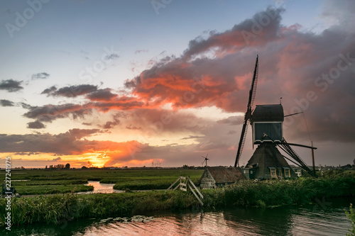 Dutch Windmill in a Polder Landscape at Sunset