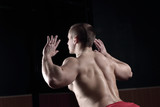 close up.rear view .a male bodybuilder performs an exercise