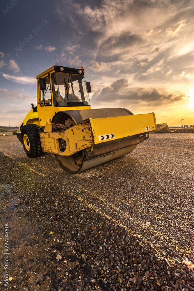 Steamroller performing road paving works Steamroller performing road paving works